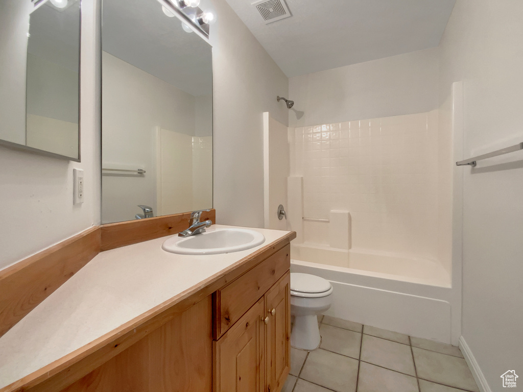 Full bathroom with tile patterned flooring, vanity, toilet, and shower / bathing tub combination