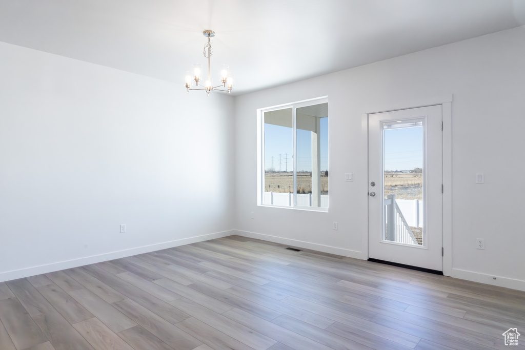 Interior space with a chandelier and light wood-type flooring