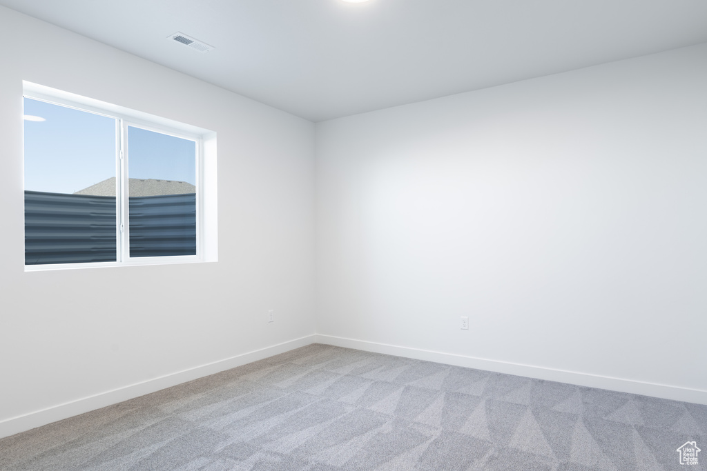 Unfurnished room with light carpet