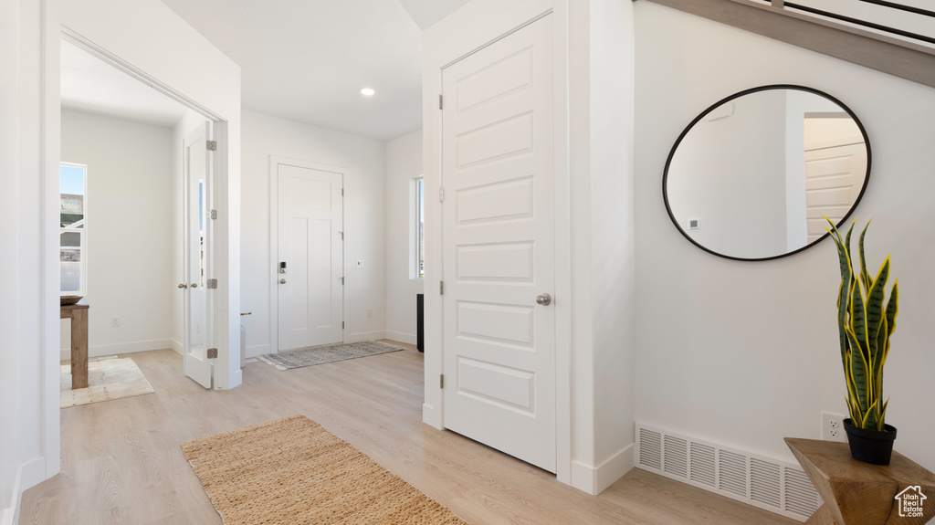 Corridor featuring light wood-style flooring, recessed lighting, and baseboards