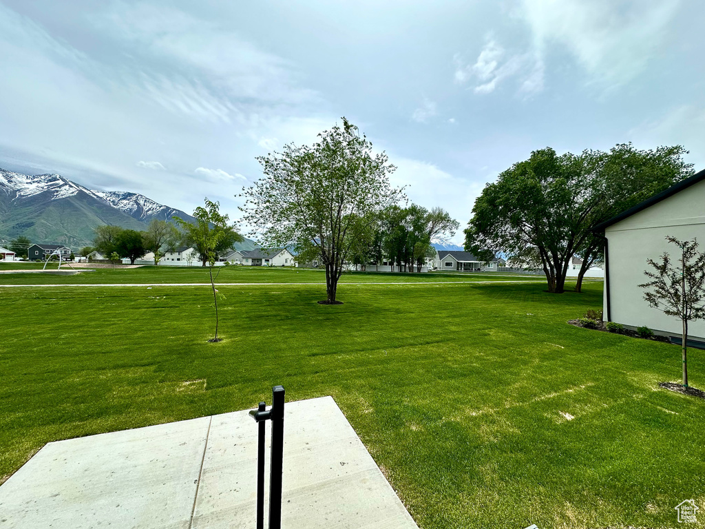 View of grassy yard featuring a mountain view