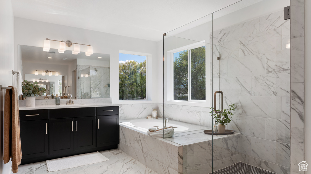 Bathroom with a marble finish shower, a garden tub, vanity, and marble finish flooring