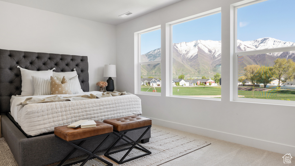 Bedroom with carpet floors, a mountain view, and baseboards