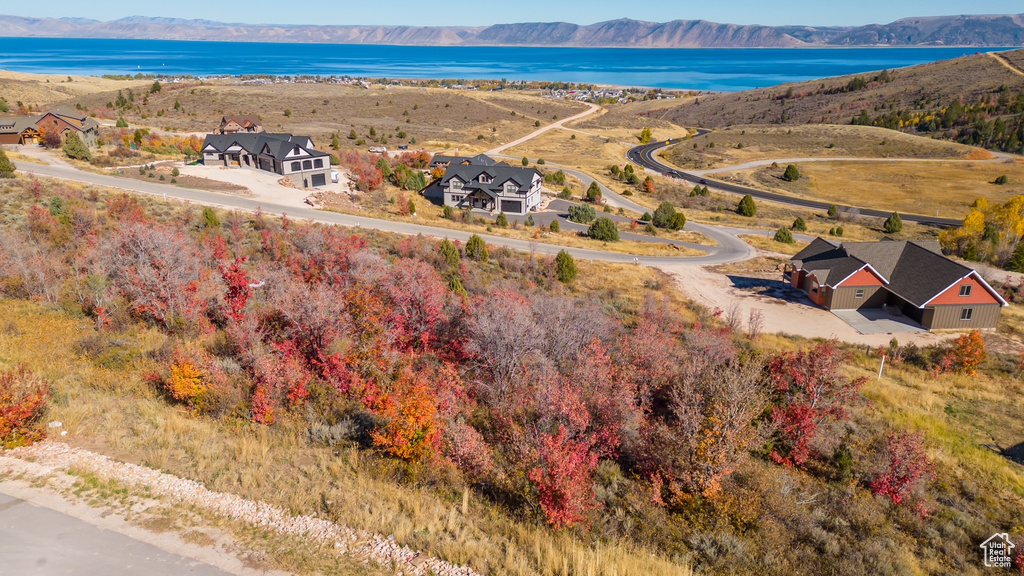 Birds eye view of property featuring a water and mountain view