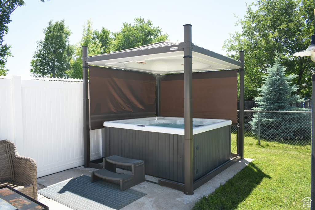 View of patio / terrace with a hot tub
