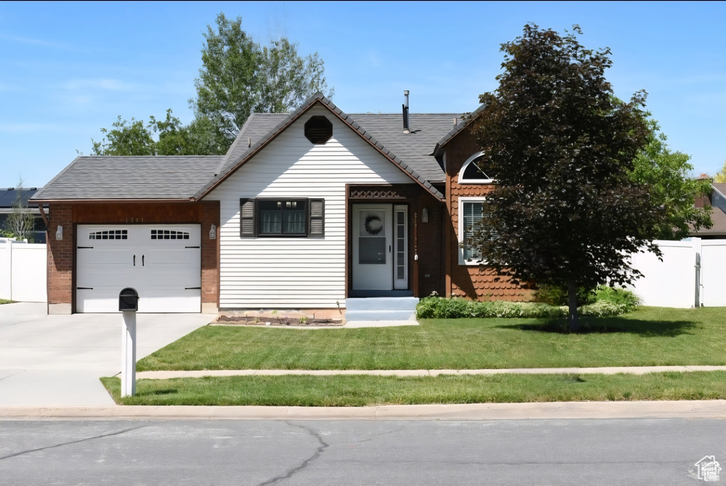 View of front of home with a garage and concrete driveway