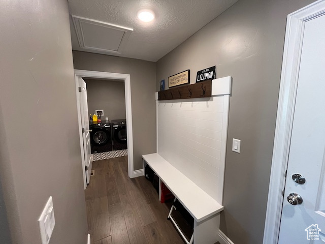 Mudroom with baseboards, a textured ceiling, separate washer and dryer, and dark wood-style floors