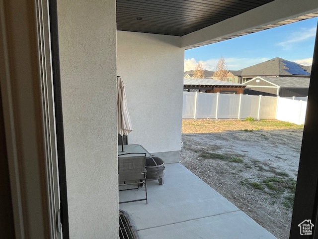 View of patio with fence
