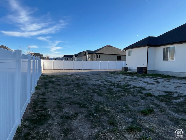 View of yard with a fenced backyard and a residential view