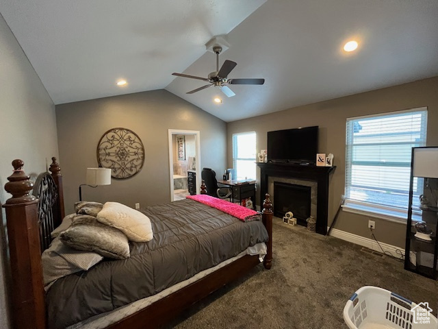 Bedroom featuring lofted ceiling, baseboards, a fireplace, carpet floors, and ceiling fan