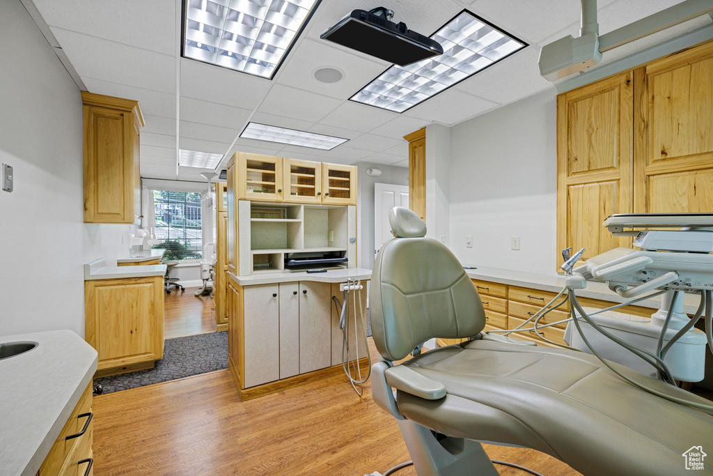 Office featuring light wood finished floors and a paneled ceiling