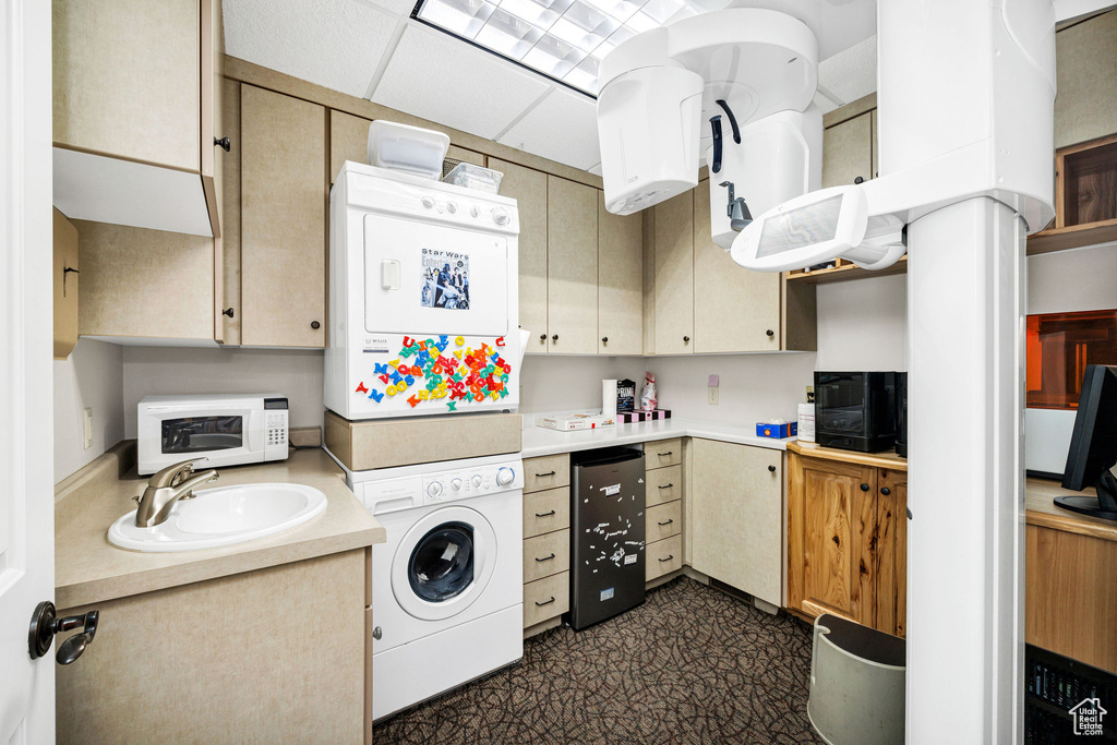 Kitchen featuring a drop ceiling and sink