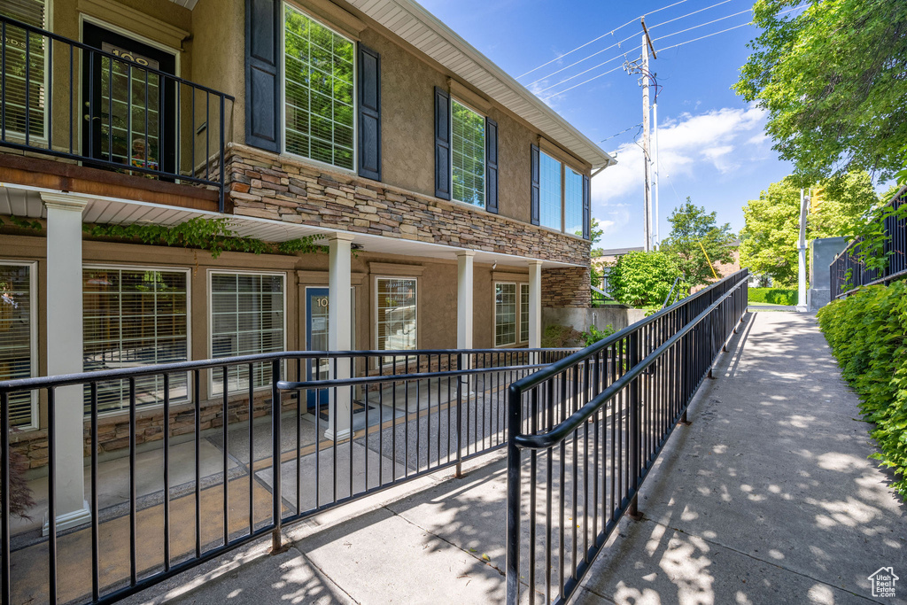 View of side of property featuring stucco siding and stone siding