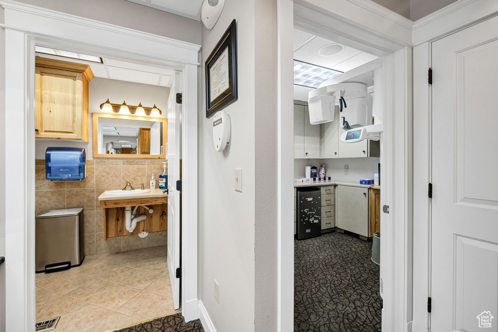 Bathroom featuring tile walls, sink, and tile patterned floors