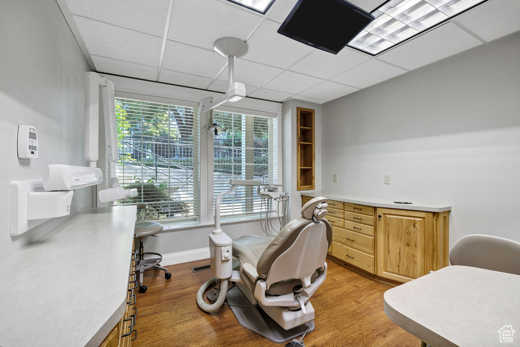 Office featuring light wood-style floors and a drop ceiling