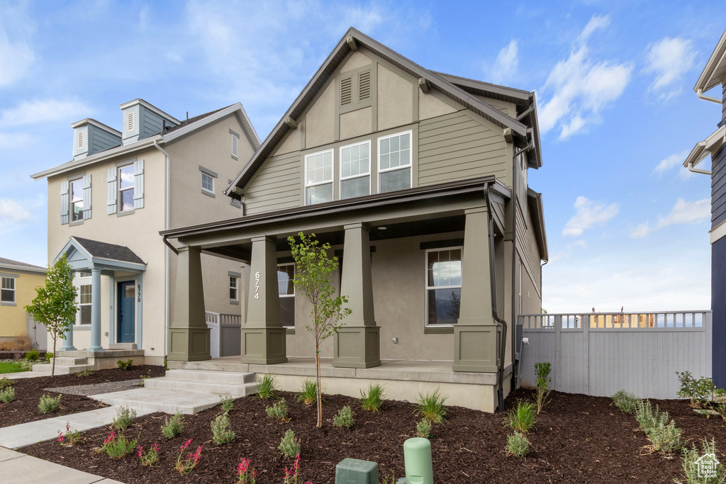 View of front of house featuring a porch and stucco siding