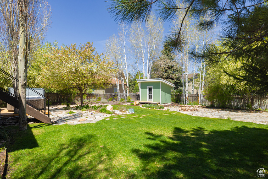 View of yard featuring an outdoor structure and a patio area