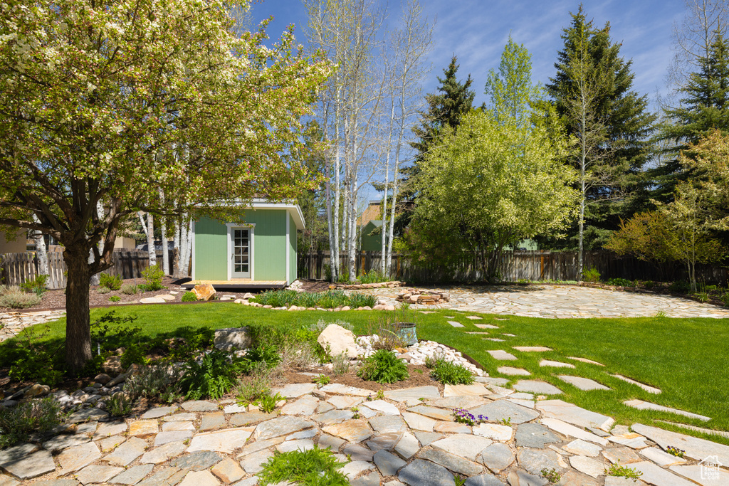 View of yard featuring an outdoor structure and a patio