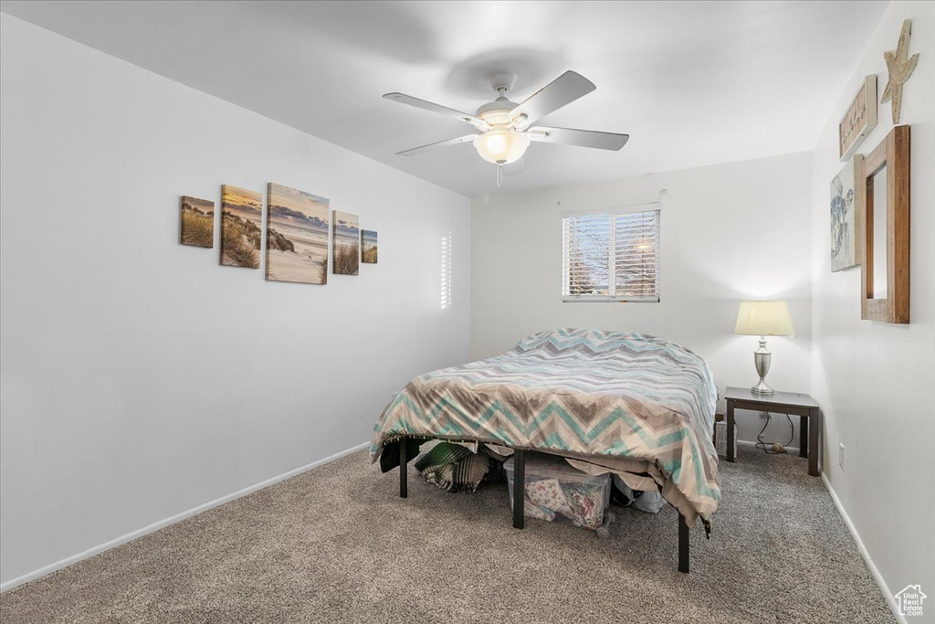 Bedroom featuring ceiling fan and carpet