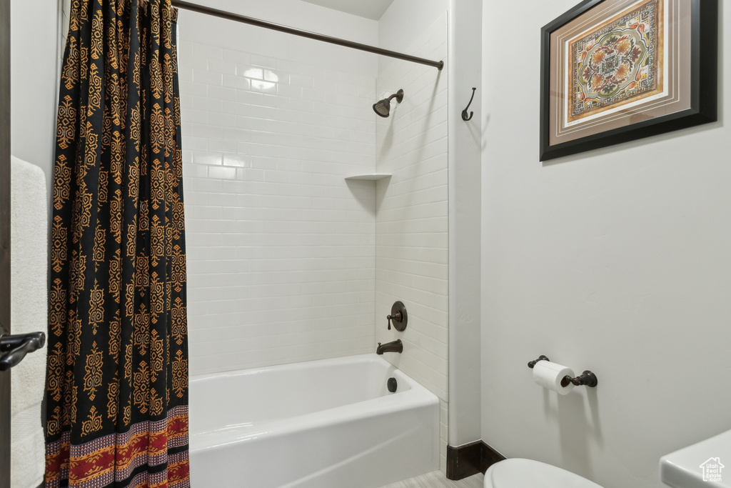 Bathroom with shower / tub combo and toilet