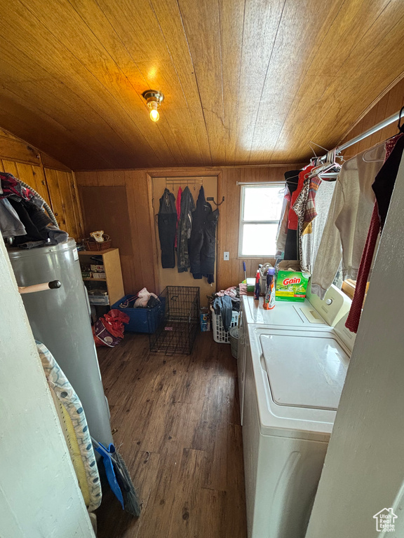Laundry room featuring washing machine and dryer, dark wood-type flooring, wooden walls, and wood ceiling