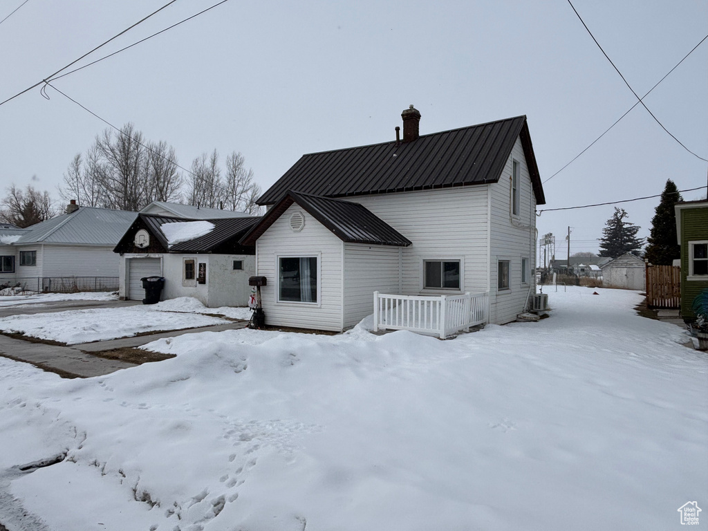 View of snow covered back of property
