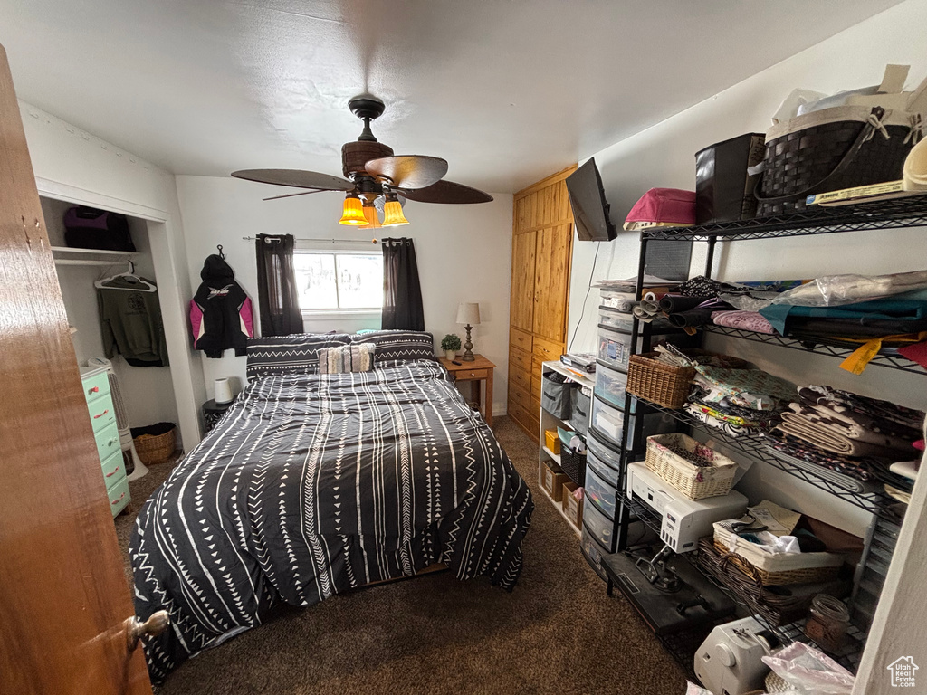 Bedroom with carpet floors, ceiling fan, and a closet
