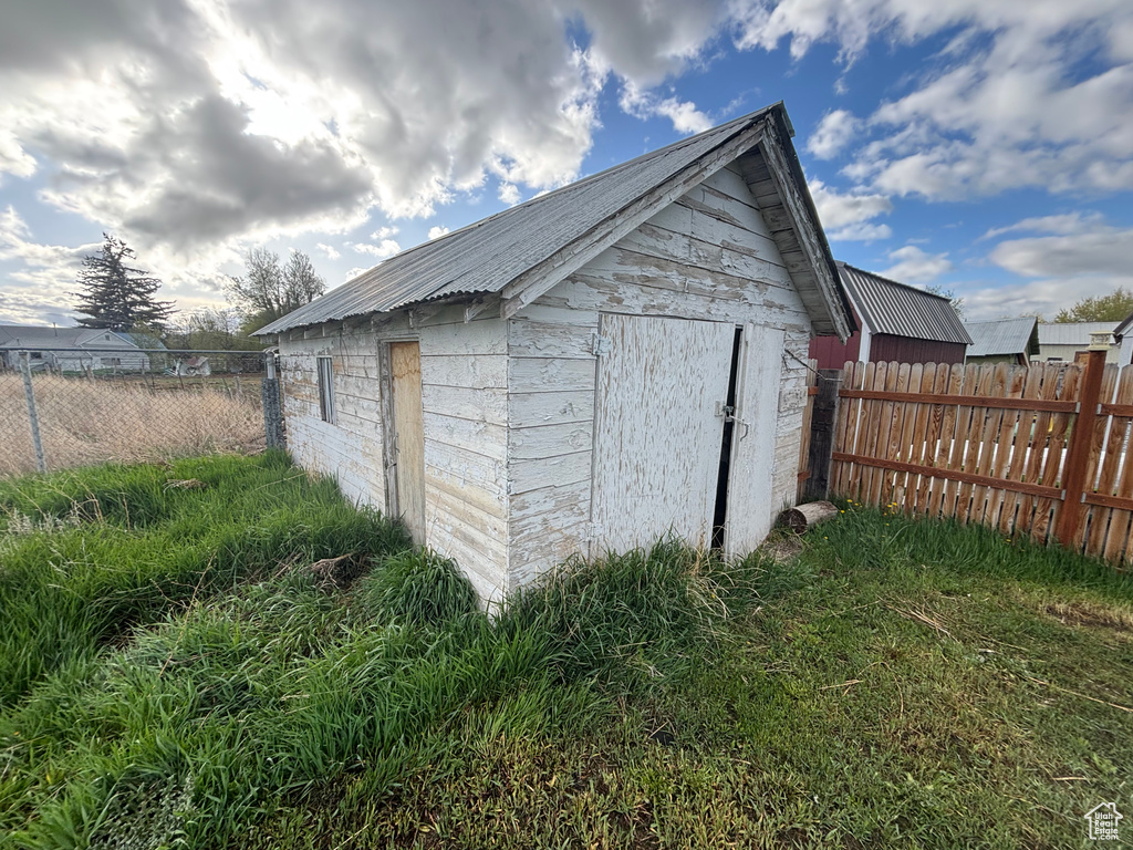 View of shed featuring fence