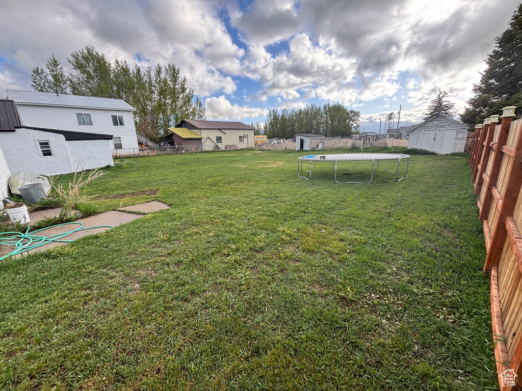 View of yard featuring a trampoline