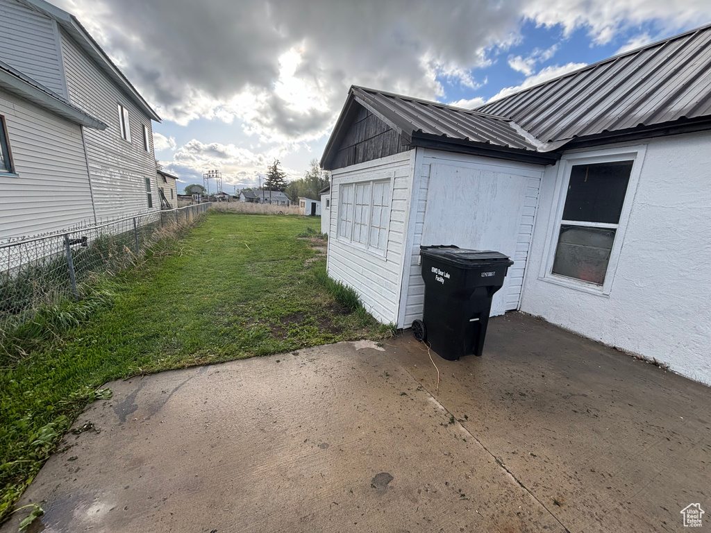 View of home's exterior with metal roof and a patio area