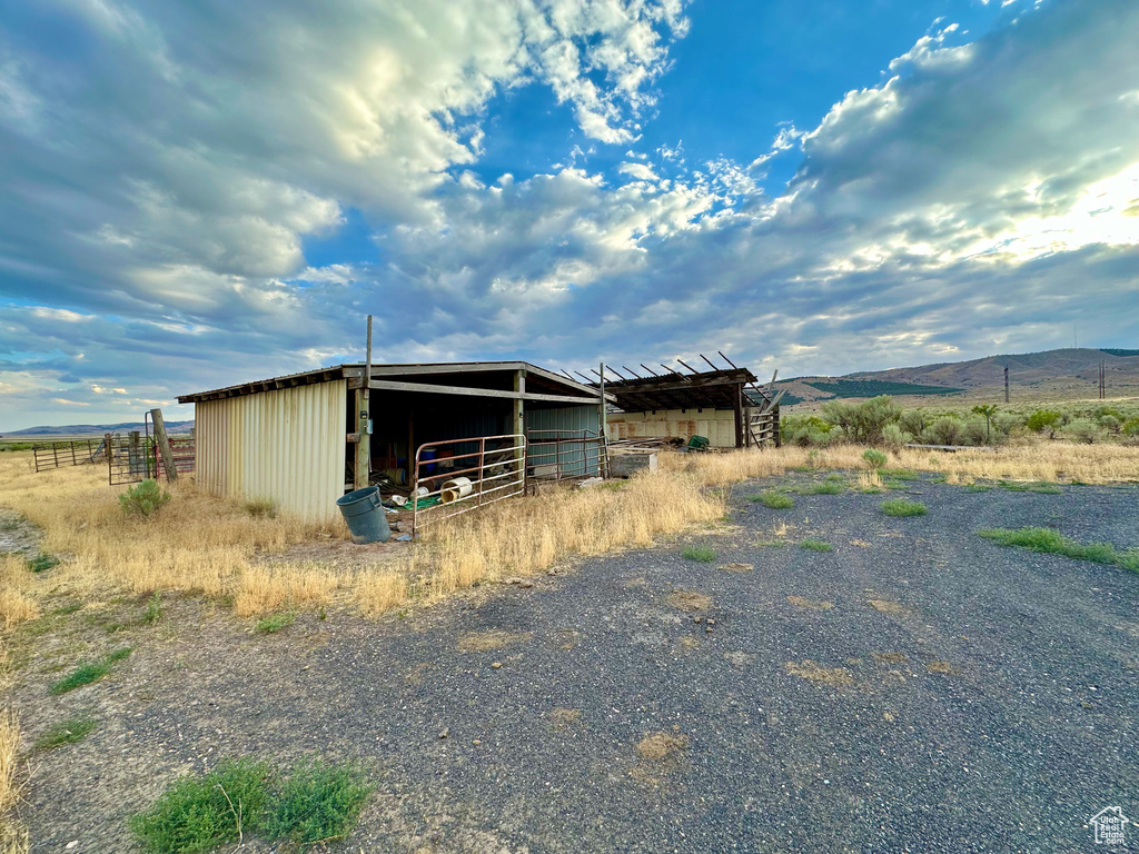 View of outdoor structure with a rural view and a mountain view