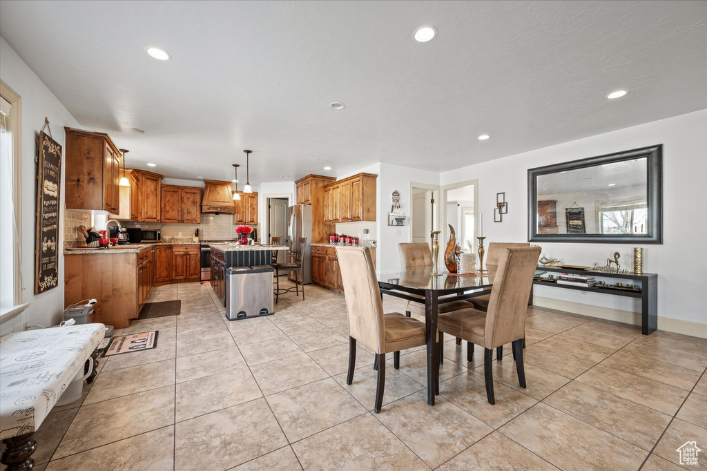 Dining space with sink and light tile patterned flooring