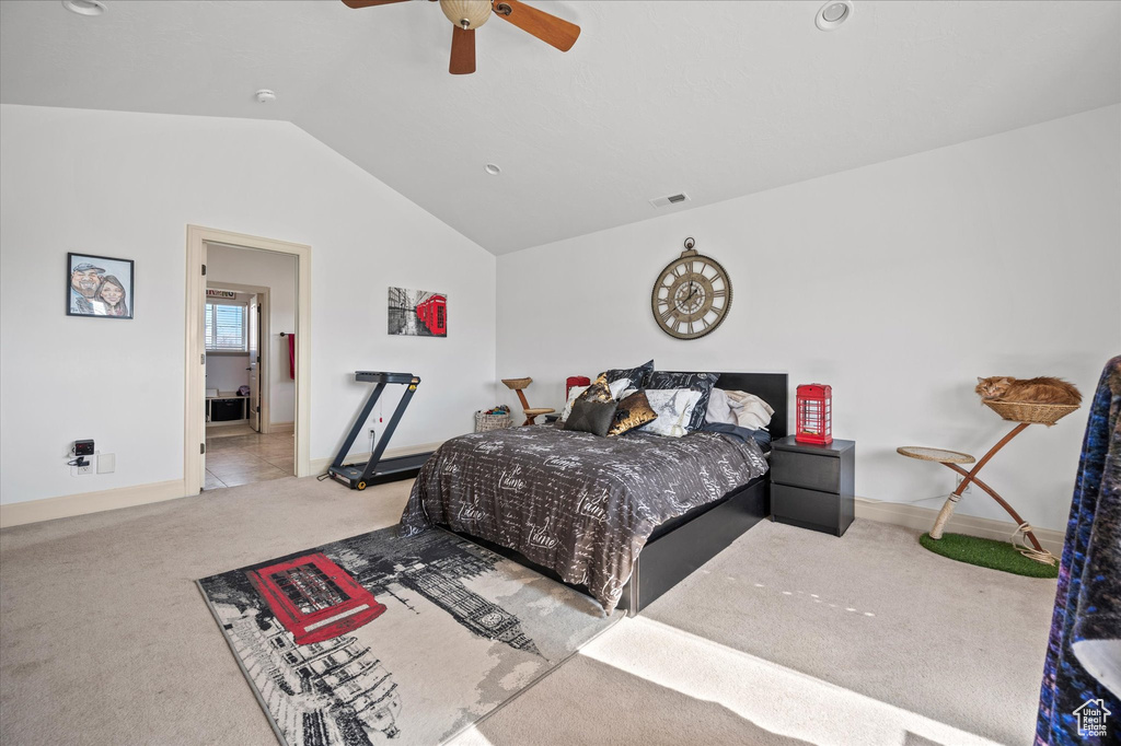 Carpeted bedroom featuring ceiling fan and lofted ceiling