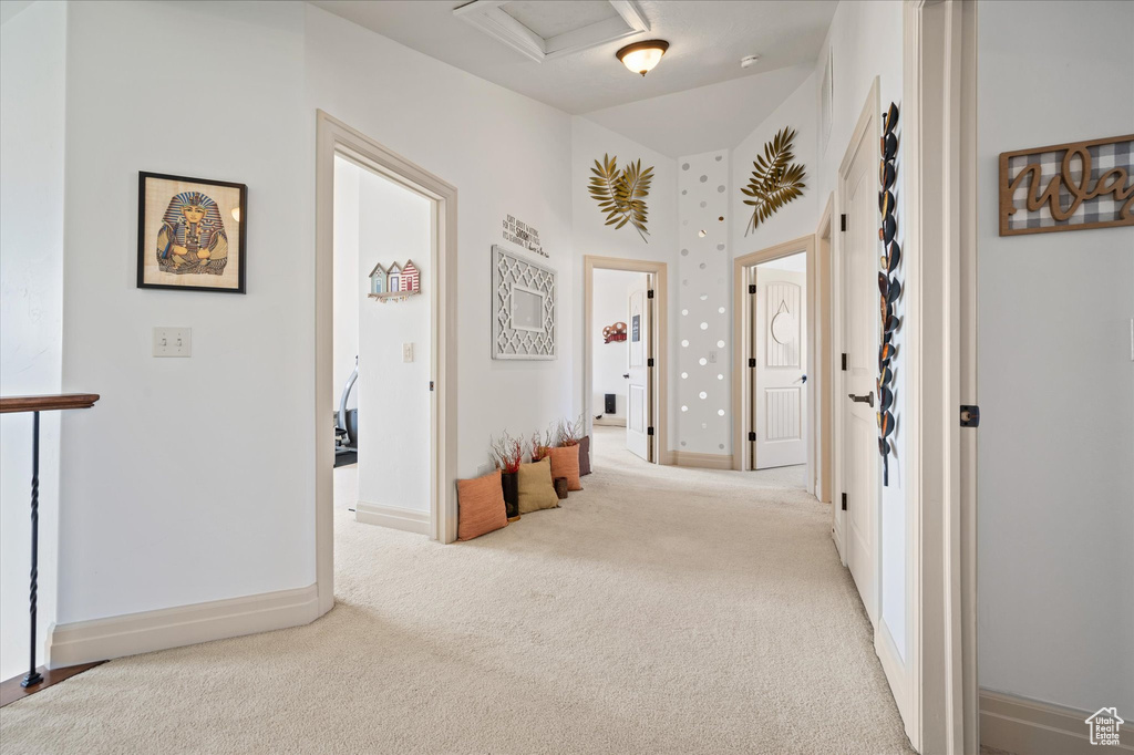 Hall featuring light colored carpet