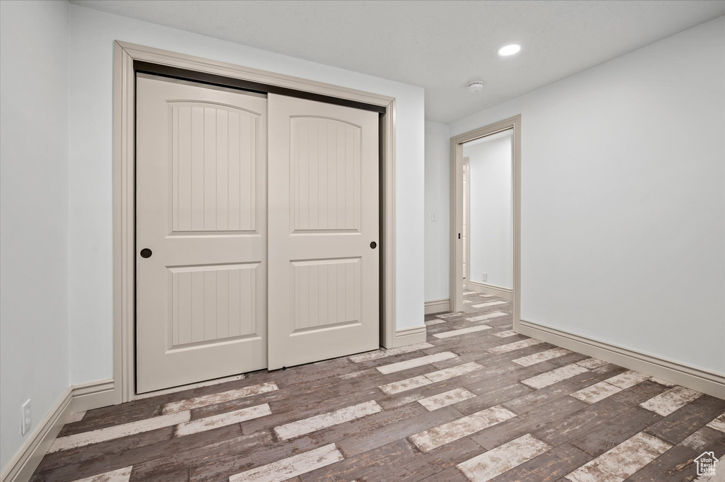 Unfurnished bedroom with hardwood / wood-style flooring and a closet