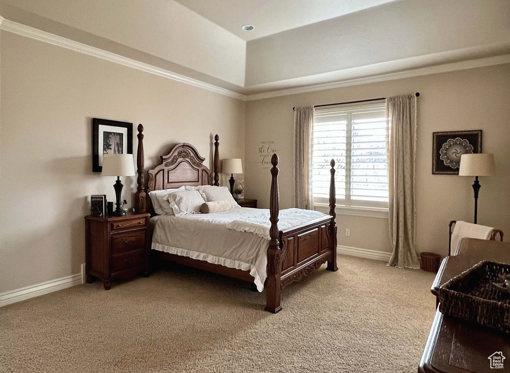 Carpeted bedroom with ornamental molding