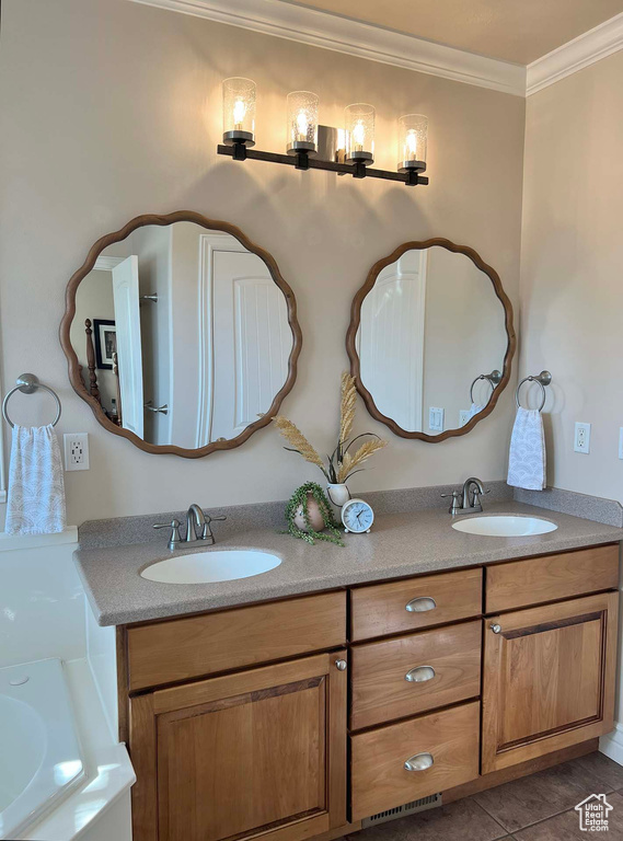 Bathroom with ornamental molding, tile patterned floors, and vanity