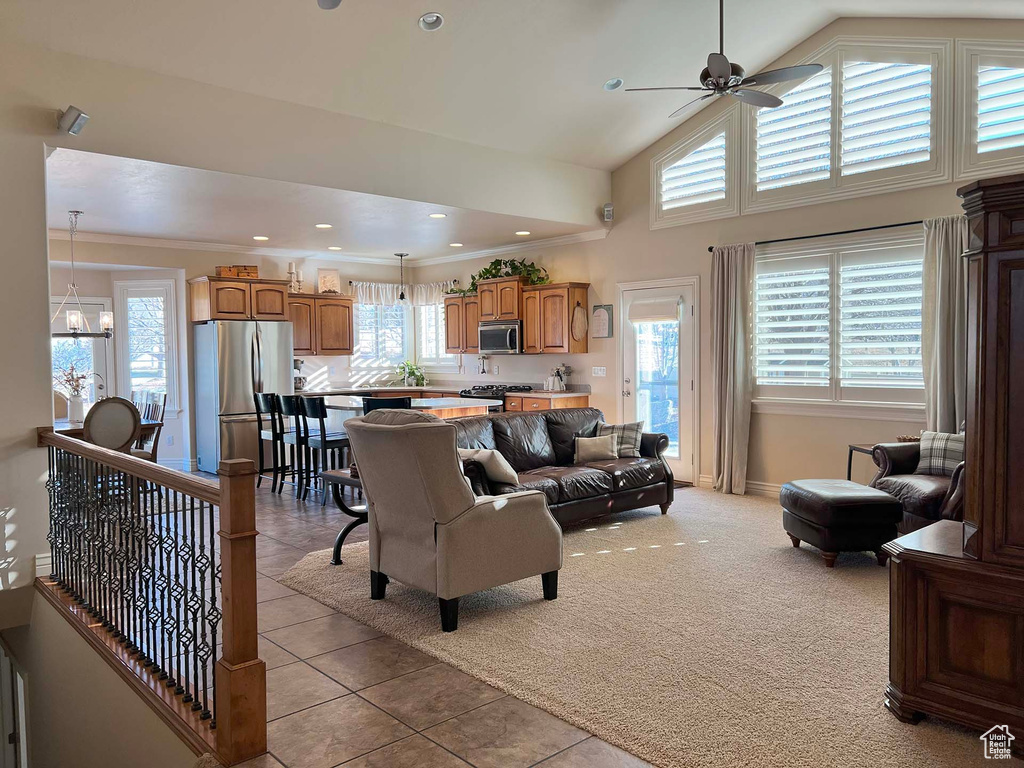 Living room featuring light carpet, plenty of natural light, and ornamental molding