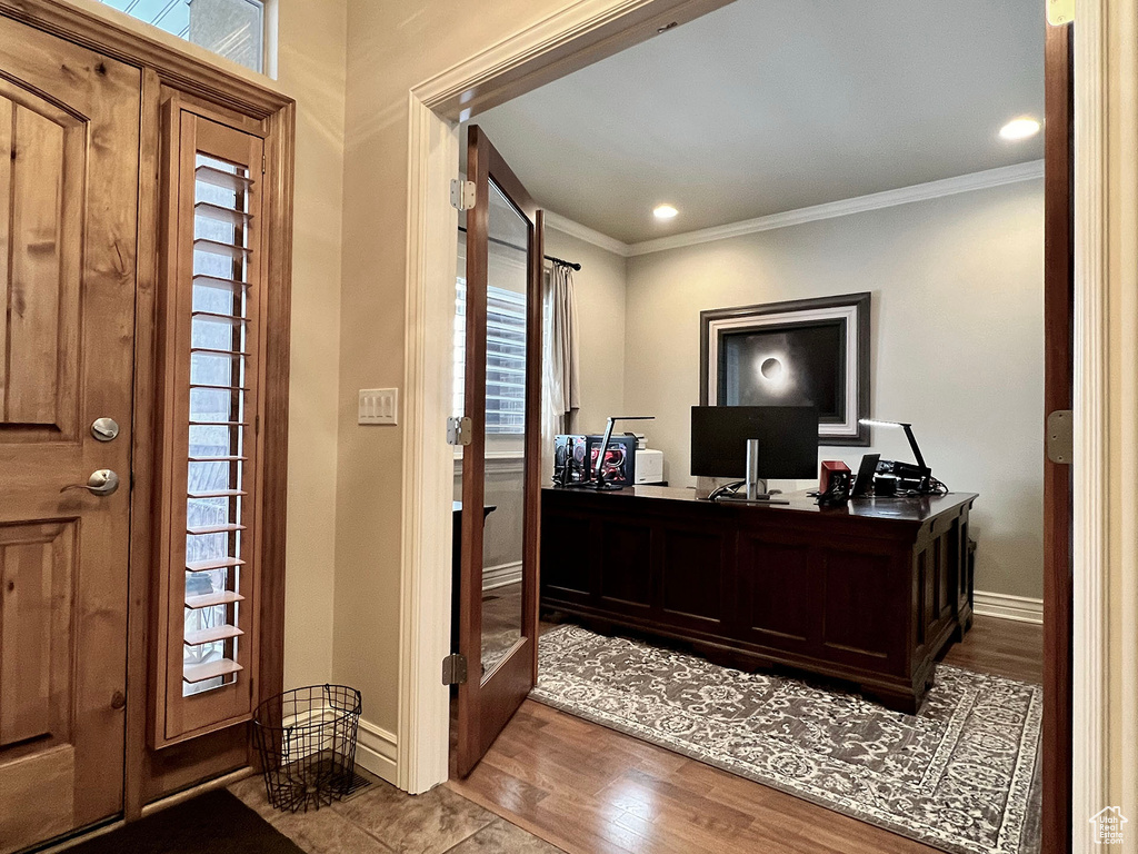 Office featuring hardwood / wood-style flooring and crown molding