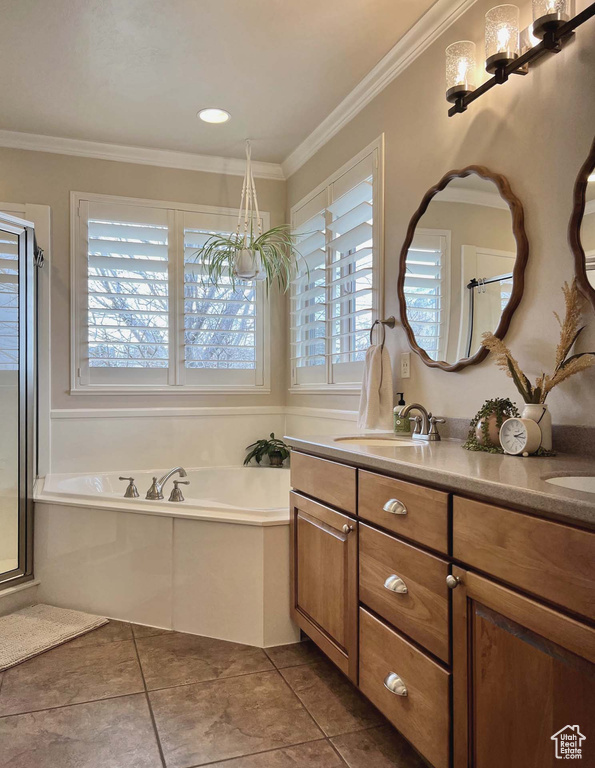 Bathroom featuring vanity, tile patterned floors, ornamental molding, and independent shower and bath