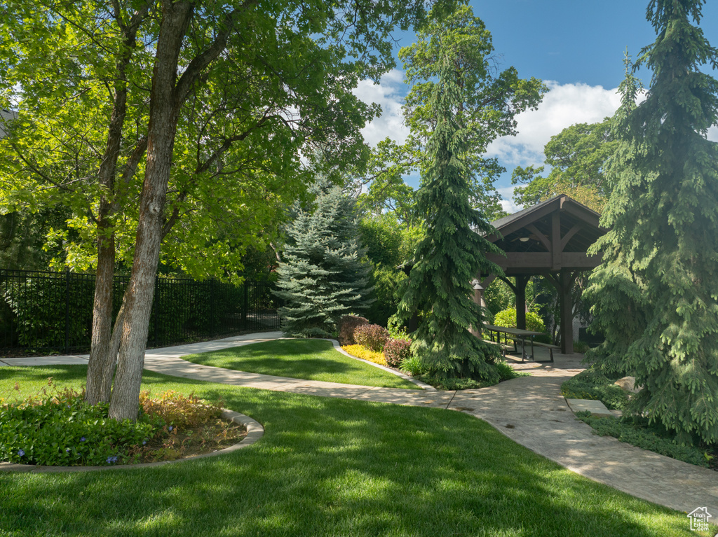 View of property's community with a gazebo and a lawn