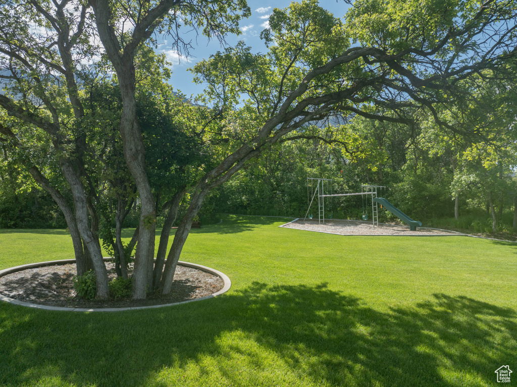 View of green lawn featuring a playground