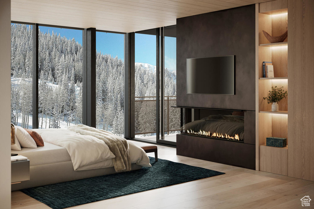 Bedroom with hardwood / wood-style flooring and expansive windows