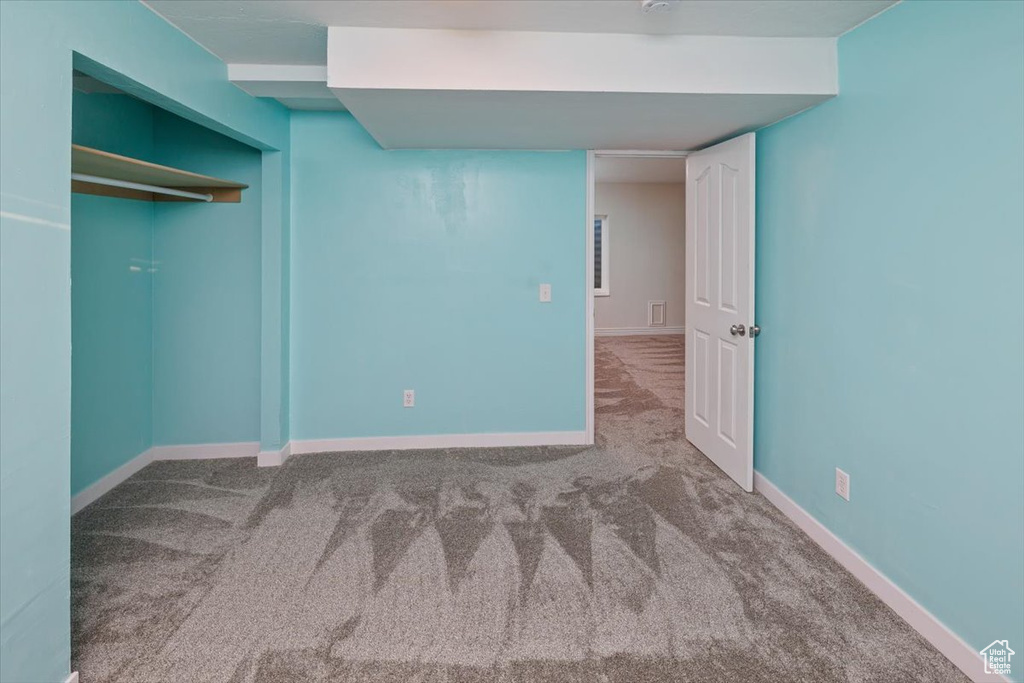 Unfurnished bedroom featuring a closet and carpet flooring