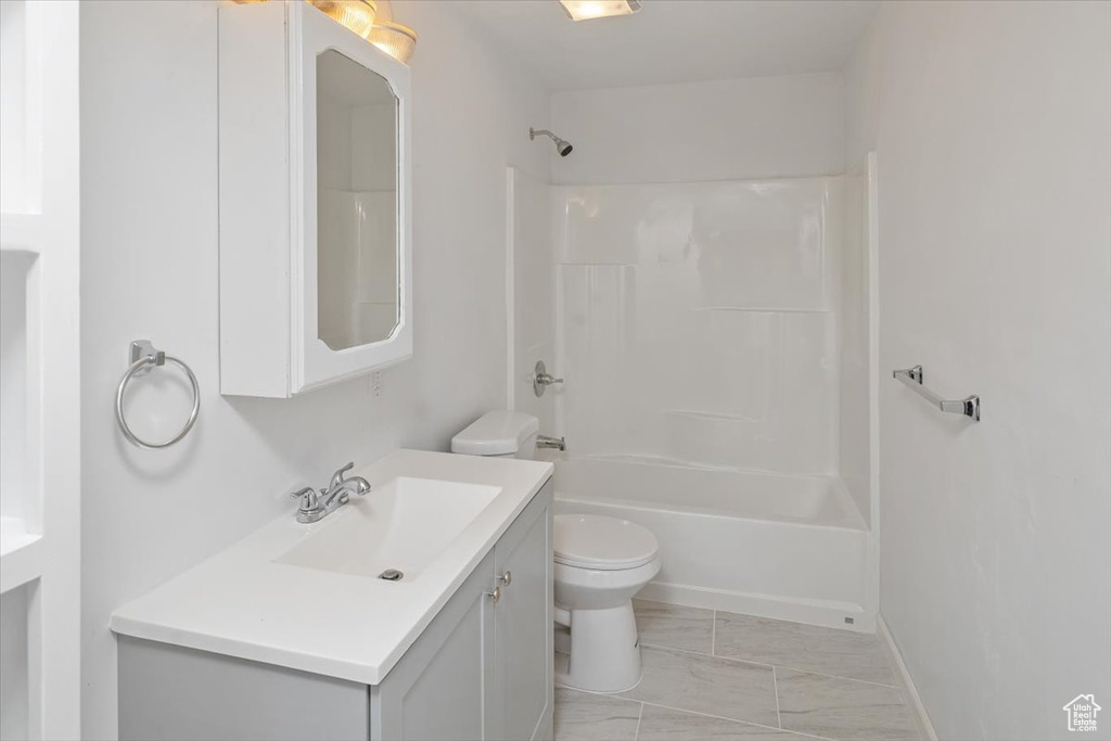 Full bathroom featuring vanity, bathtub / shower combination, and toilet