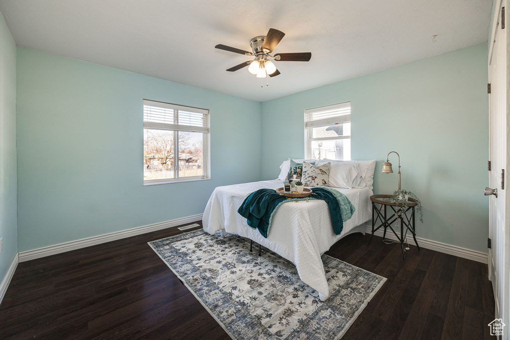 Bedroom featuring ceiling fan and dark hardwood / wood-style floors