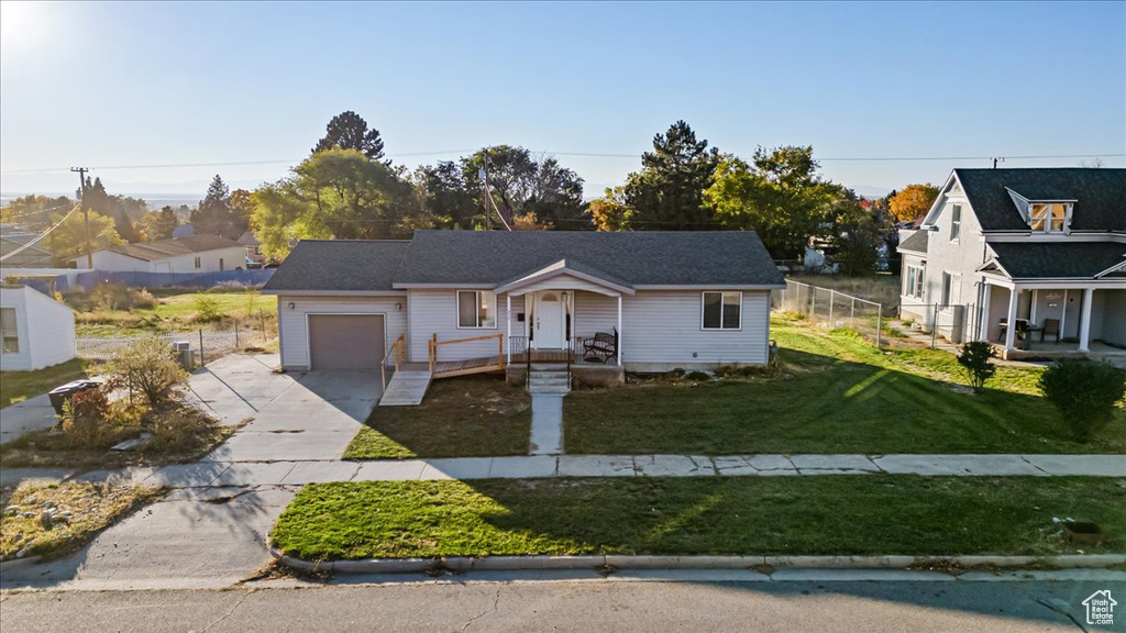 Bungalow-style home with a garage and a front yard