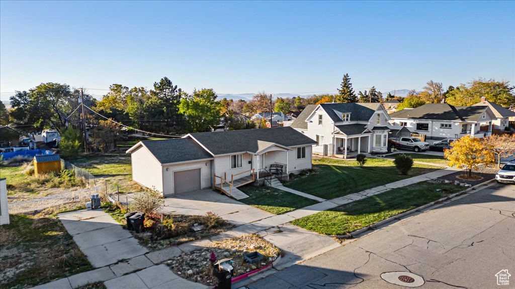 View of front of home featuring a garage and a front yard