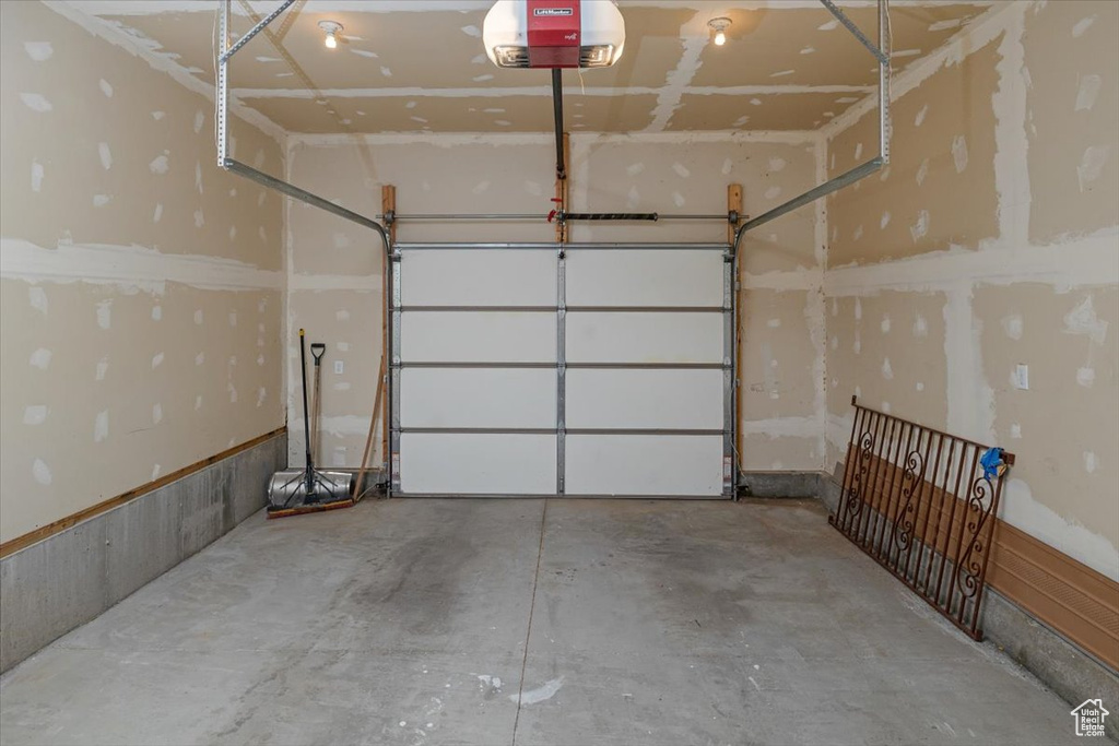 Garage featuring a garage door opener