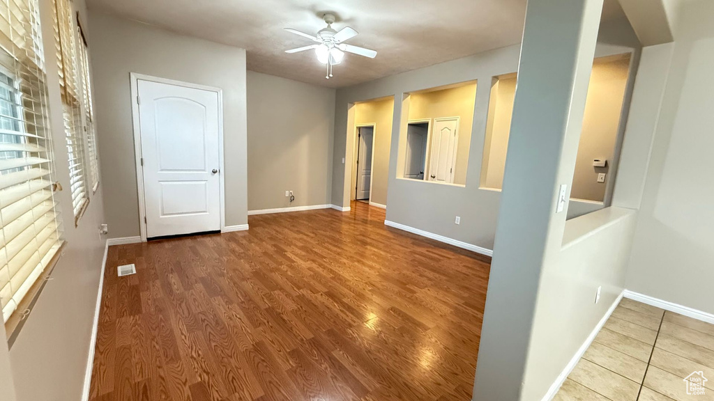 Spare room with hardwood / wood-style floors and ceiling fan